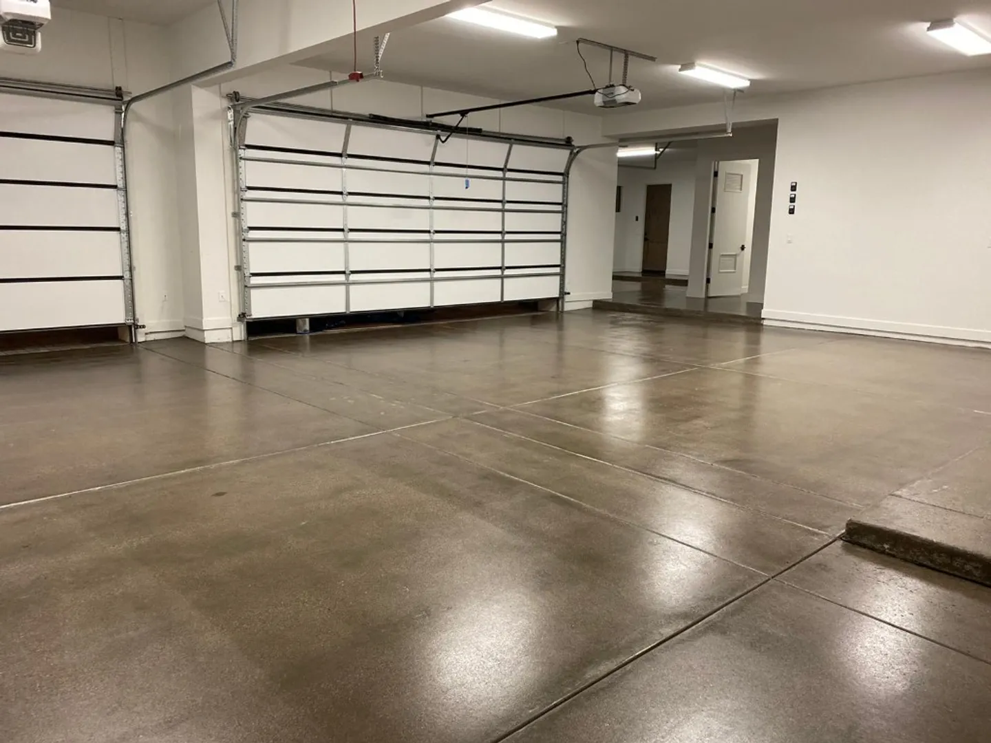 Grind and seal concrete floor with a clean satin finish in a Central NJ residential garage