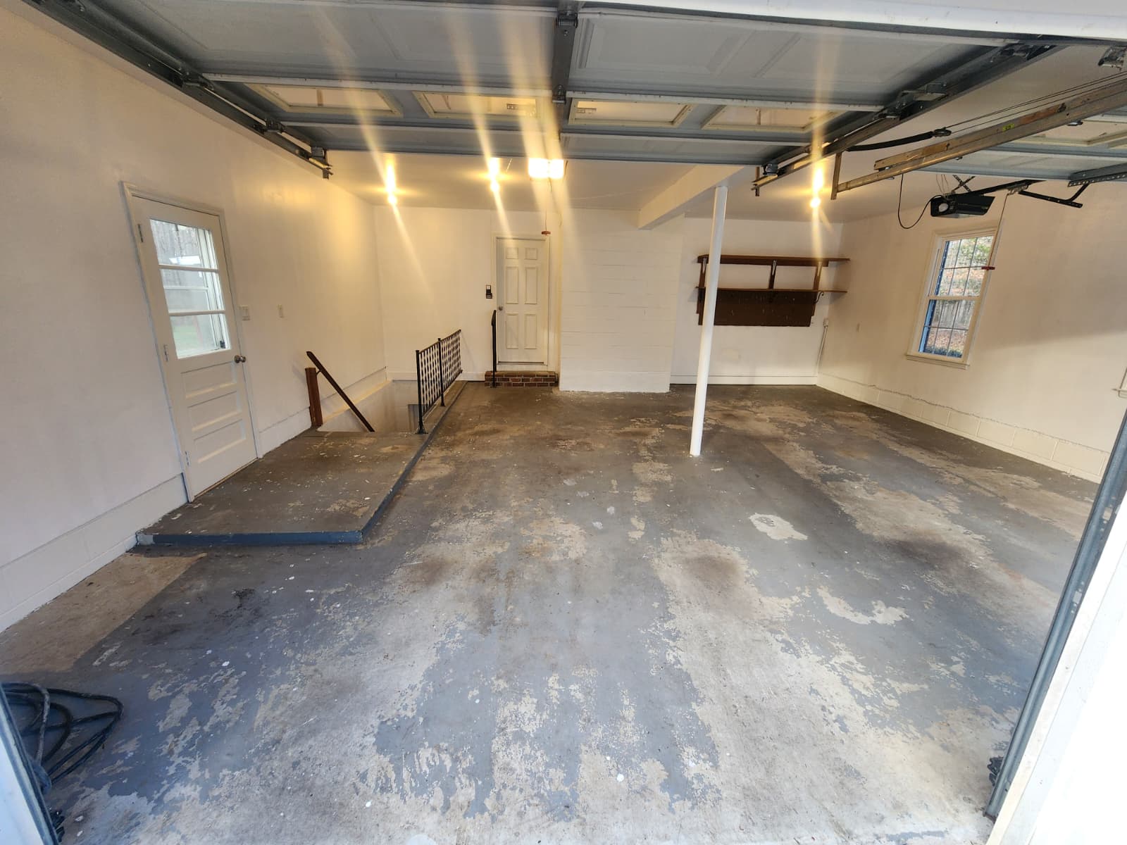 Garage floor before epoxy coating with dirty and worn concrete surface
