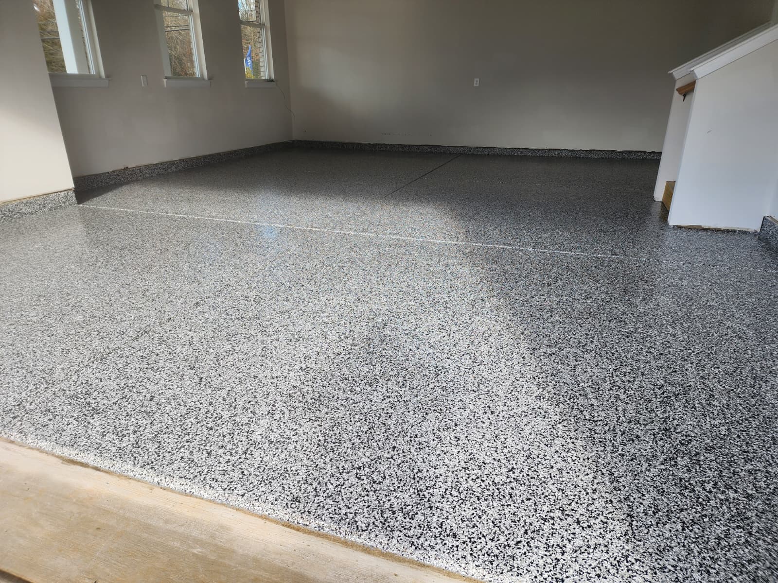 Garage floor after epoxy coating with smooth even and durable finish