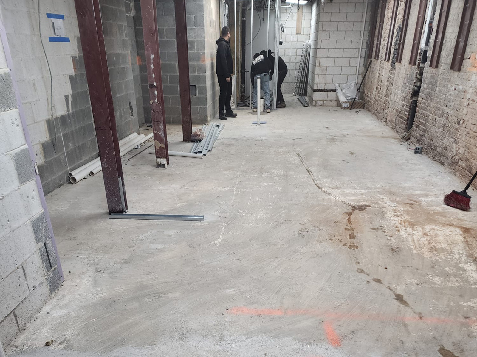 Garage floor before epoxy coating with dull and worn concrete surface